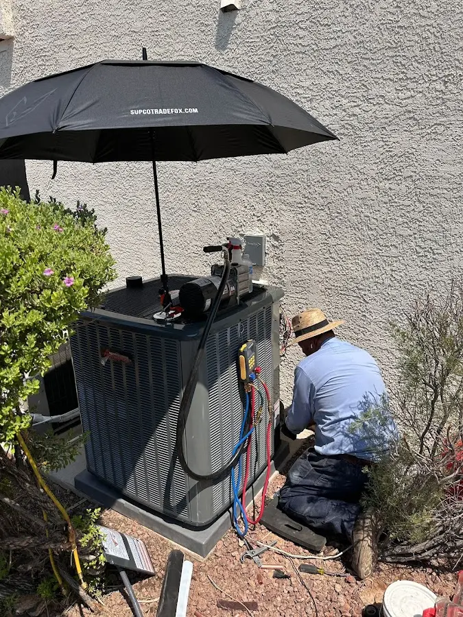 HVAC technician performing outdoor AC maintenance in Bonner Springs